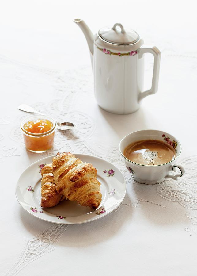 Croissants, A Glass Of Apricot Jam, A Cup Of Coffee And A Jug Of Coffee Photograph by Julia Hildebrand