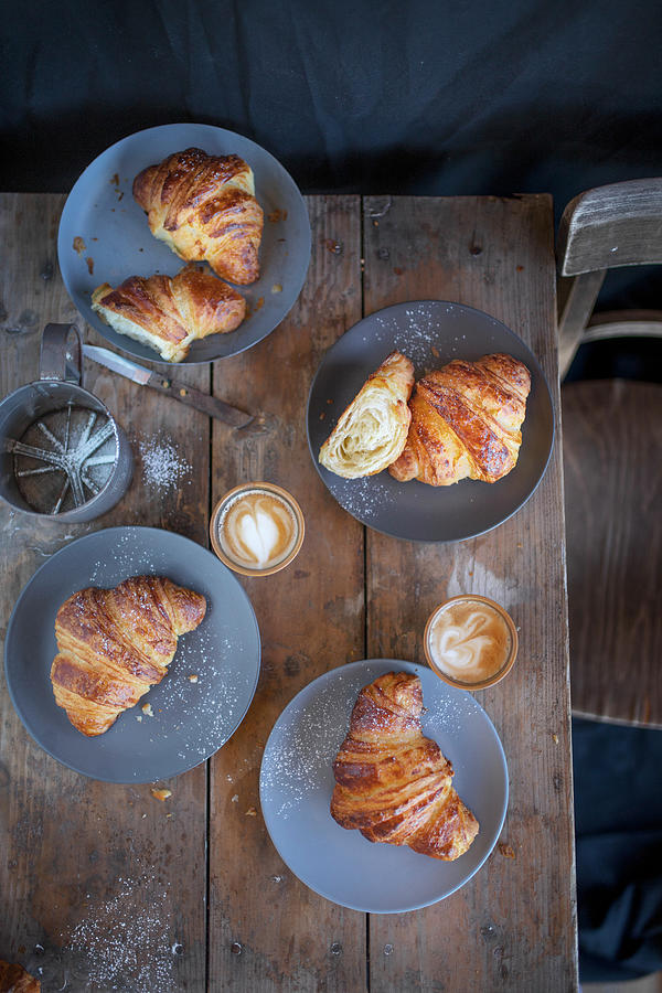 Croissants With Cappuccinos On A Rustic Wooden Table top View Photograph by Anna-lena Rpfl