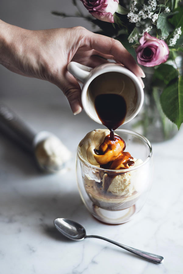 Ice Cream Photograph - Cropped Image Of Woman Pouring Chocolate Sauce On Affogato by Cavan Images