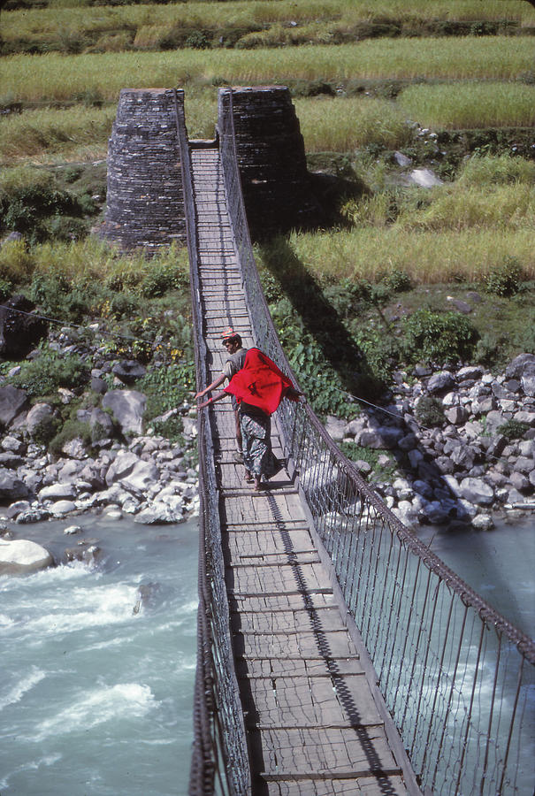 Crossing a suspension bridge Photograph by Steve Estvanik