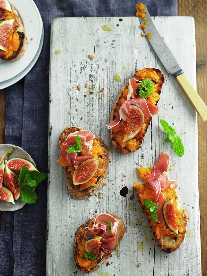 Crostini Topped With Pumpkin Pure, Parma Ham And Figs Photograph by Alex Luck