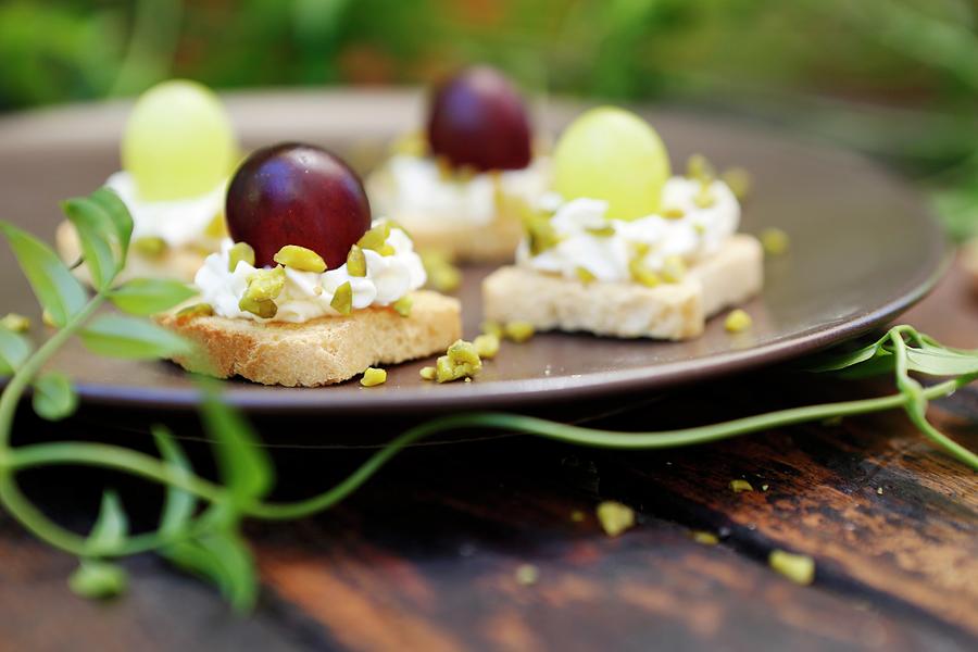 Croutons With Goats Cheese, Pistachios, And Green And Red Grapes Photograph by Viola Cajo