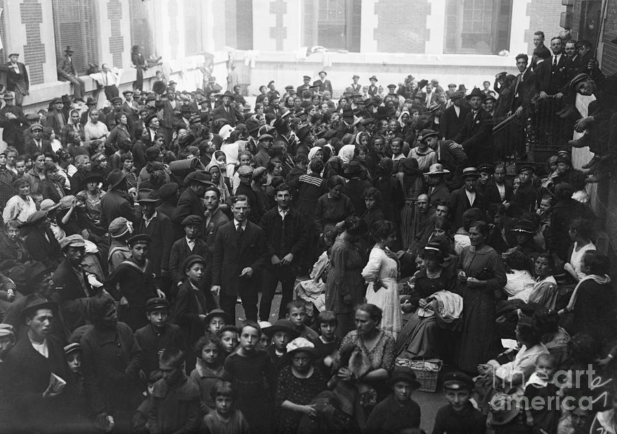 Crowd Of Immigrants Wait At Ellis Island Photograph by Bettmann