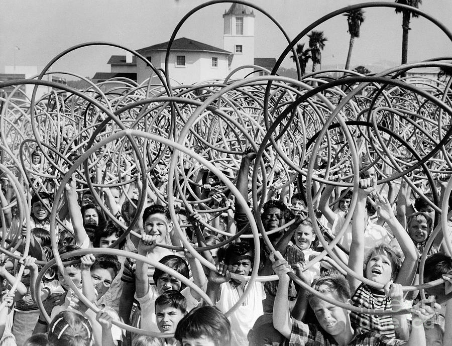 Crowd Of Kids Holding Up Hula Hoops Photograph by Bettmann