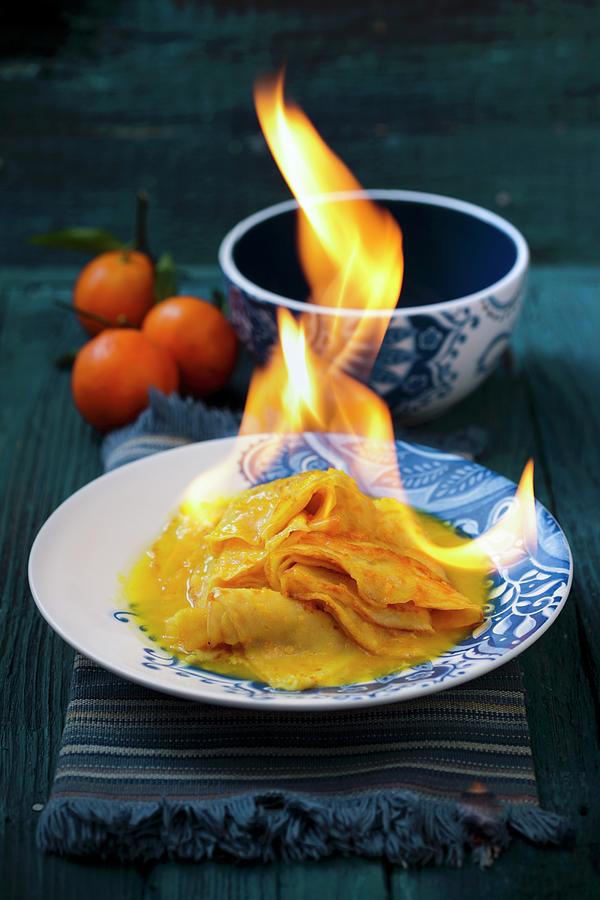 Crpe Suzette Being Flambed With Orange Syrup And Orange Liqueur Photograph by Boguslaw Bialy