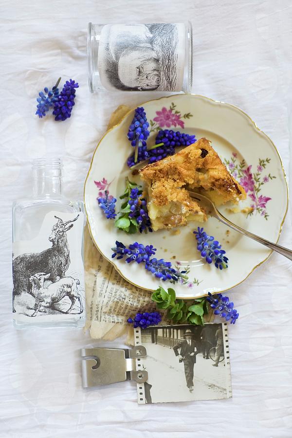 Crumb Cake And Grape Hyacinths Arranged On Vintage Plate Photograph by Alicja Koll