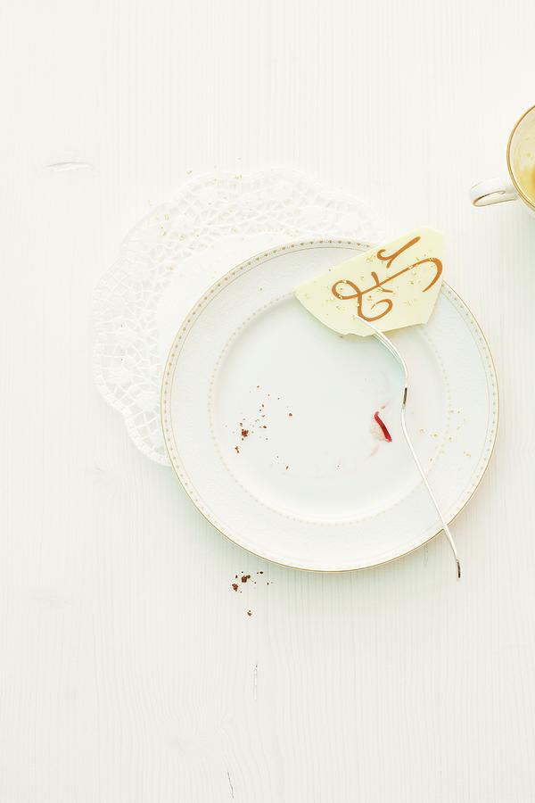 Crumbs And The Remains Of A Christmas Cake On A Plate Photograph by Michael Wissing