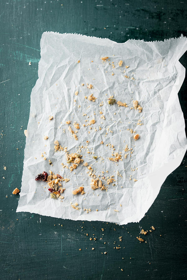 Crumbs Of Muesli Bars On A Piece Of Paper Photograph by Manuela Rther