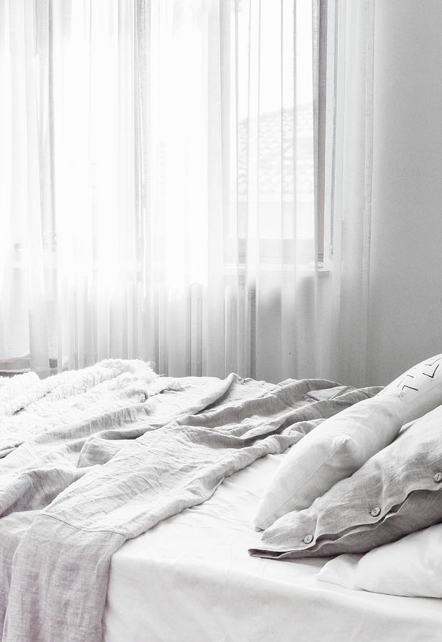 Crumpled Pale Grey Bed Linen In White Bedroom Photograph by Agata Dimmich