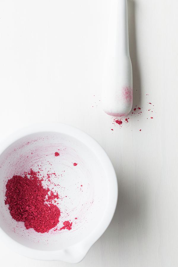Crushed Dried Raspberries In A White Mortar With A Pestle Photograph by Sarah Coghill