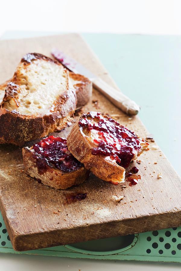 Crusty Bread On A Wooden Board With Fruit Spread Photograph by Jennifer Martine