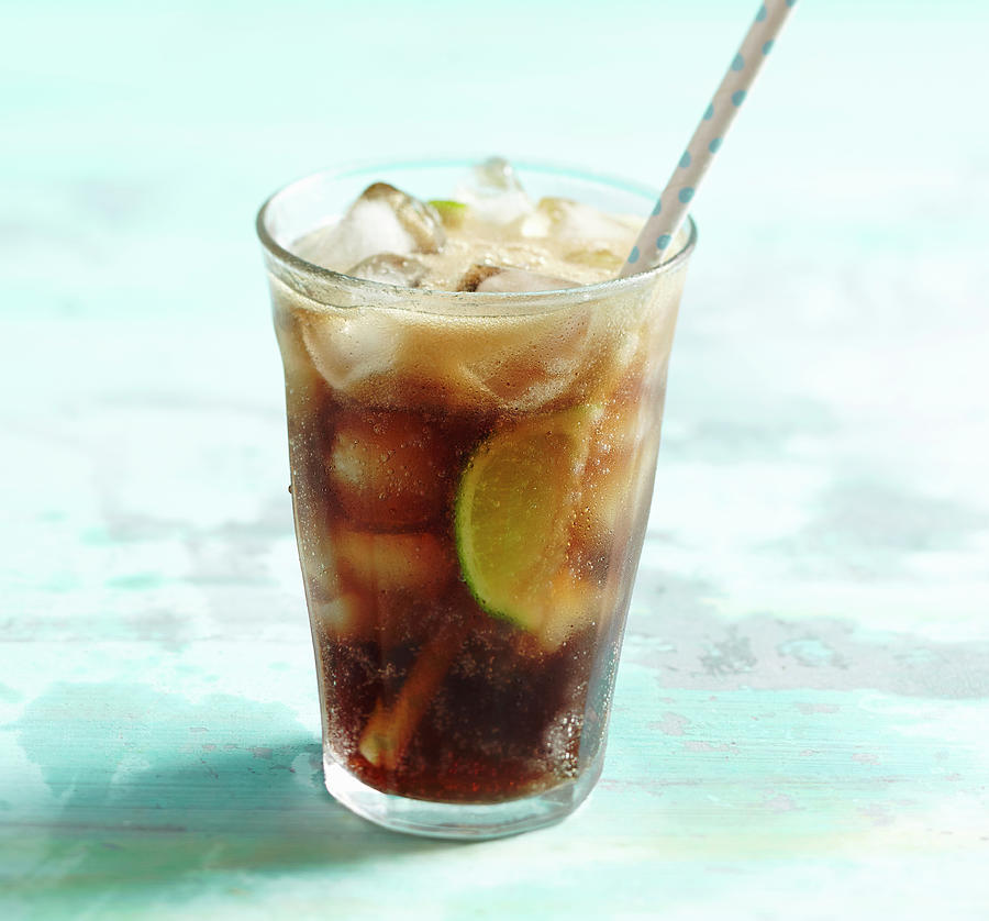 Cuba Libre With Lime, Rum, Coca Cola And Ice Cubes Photograph by Teubner Foodfoto