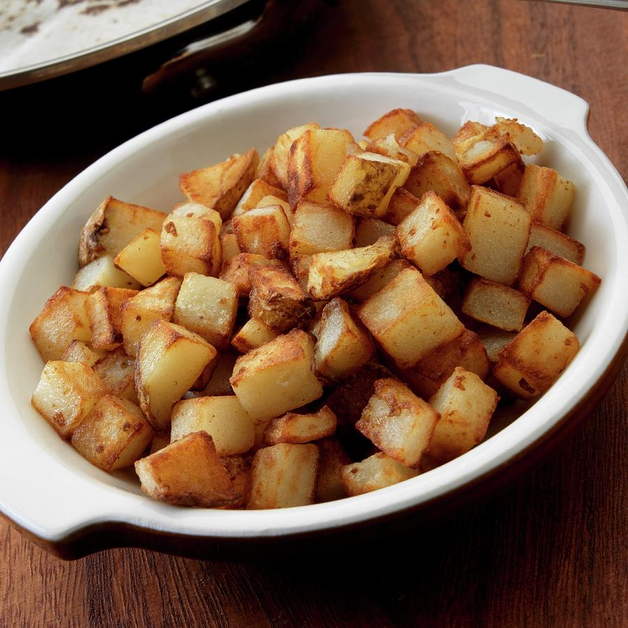 Cubed Fried Potatoes In Bowl Photograph by Paul Poplis - Fine Art America