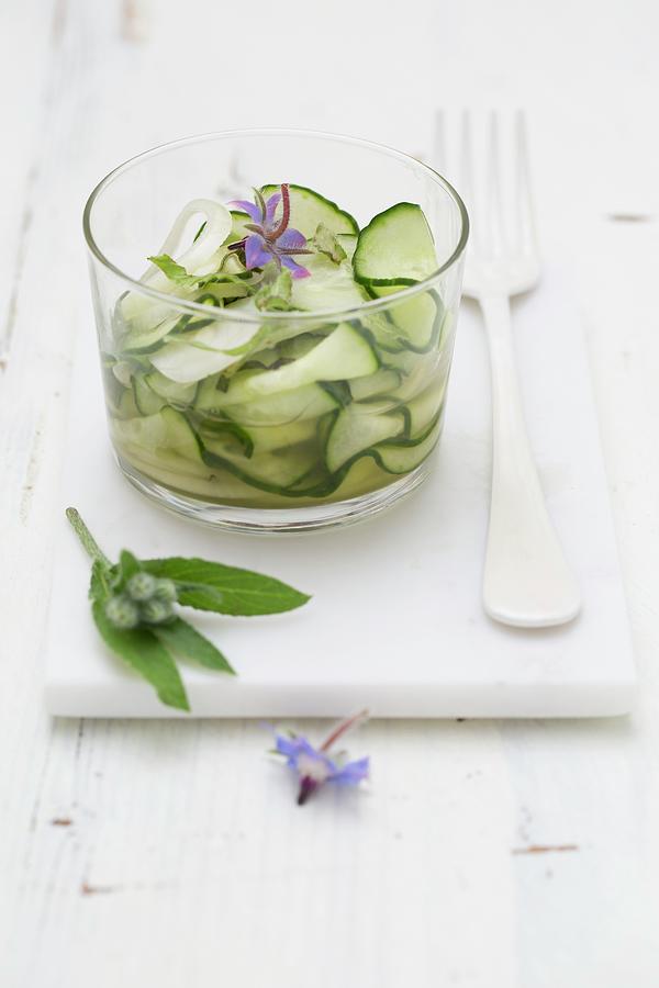 Cucumber Salad In A Glass Bowl With Borage Flowers Photograph by Tina Engel