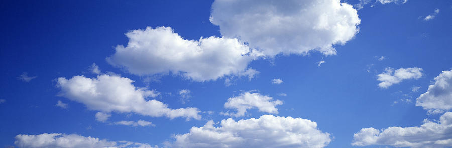 Cumulus Clouds In Blue Sky, Low Angle Photograph by Walter Bibikow