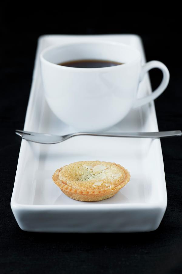 Cup Of Coffe With Small Almond Tart Photograph by Magdalena Hendey