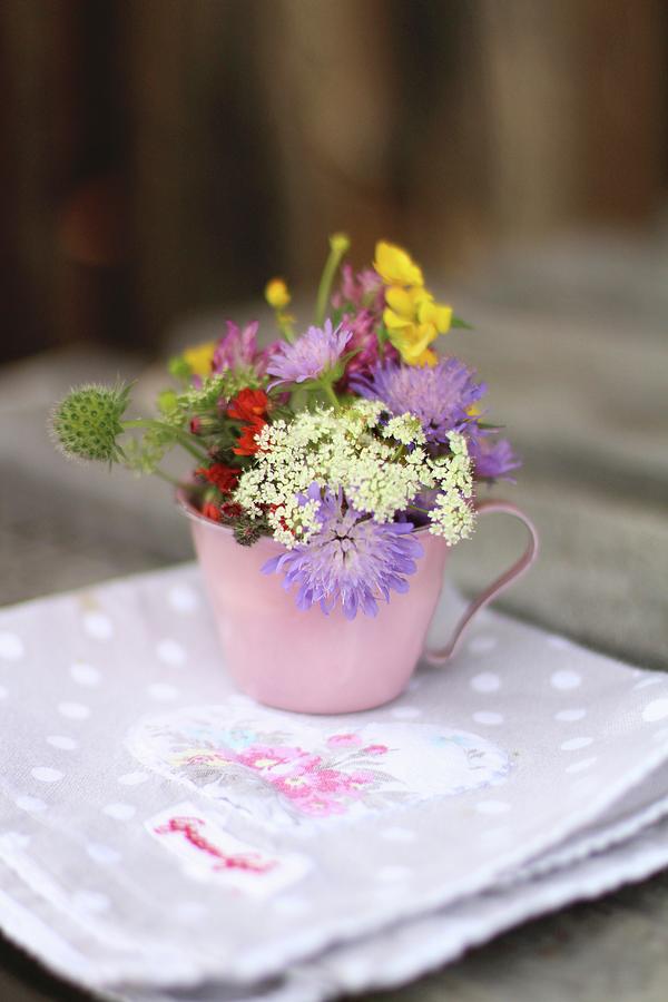 Cup Of Wild Flowers On Rustic Napkin Photograph by Sylvia E.k Photography