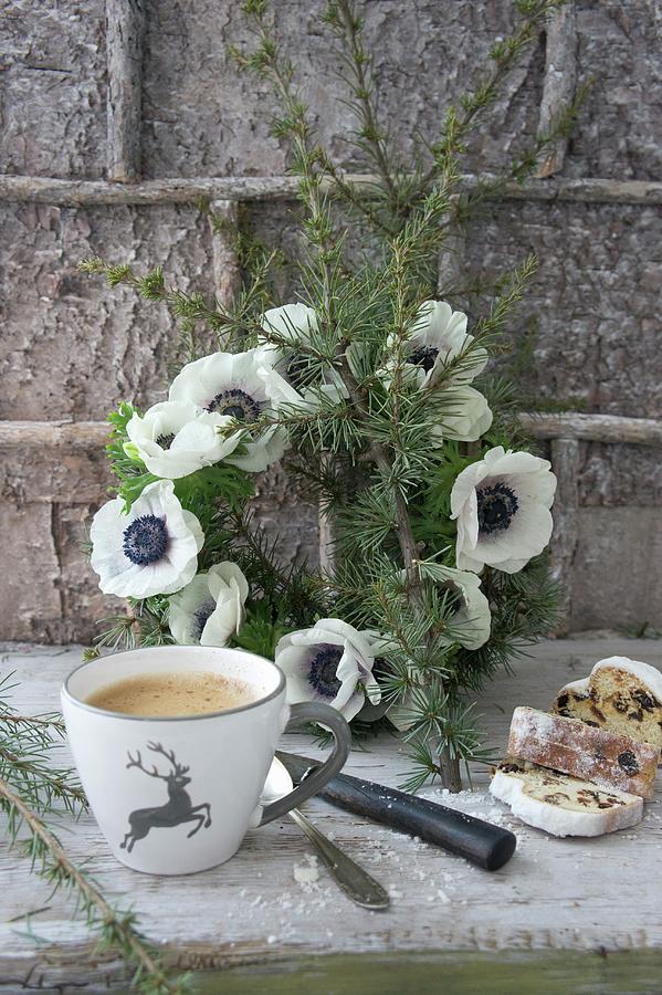 Cup With Stag Motif And Sliced Stollen In Front Of Wreath Of Anemones Photograph by Martina Schindler