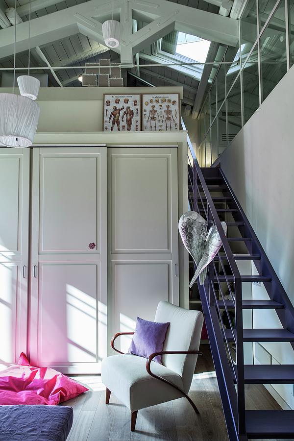 Cupboard With Panelled Doors Next To Purple Staircase Leading To Attic Photograph by Laura Rizzi