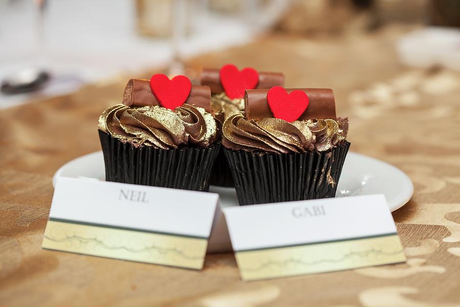 Cupcakes With Golden Frosting, Chocolate Logs And Hearts At A Wedding Photograph by Creative Photo Services