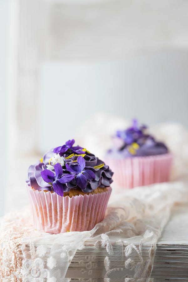 Cupcakes With Violets, Daisies, And Dandelion Petals Photograph by Mandy Reschke
