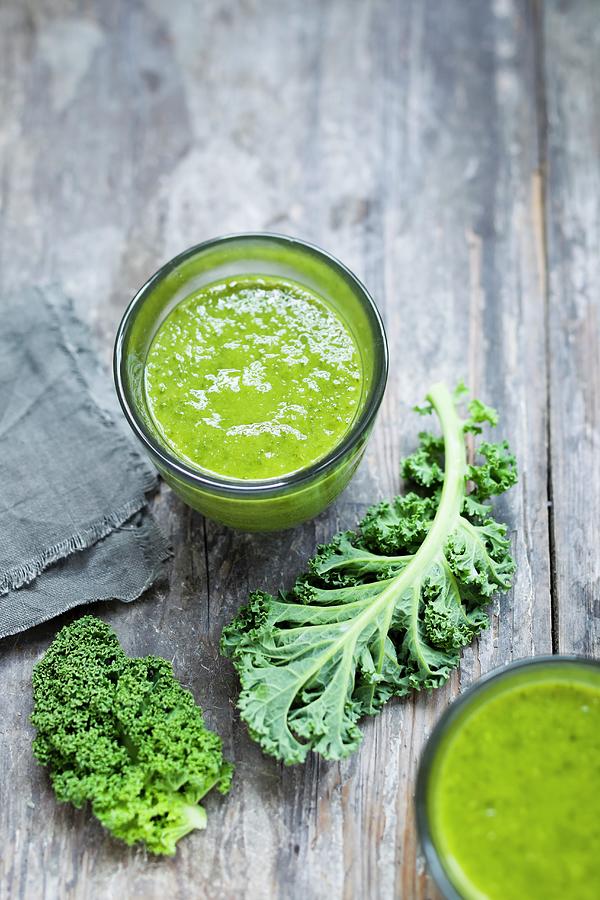 Curly Kale Smoothies In Glasses Photograph by Brigitte Sporrer