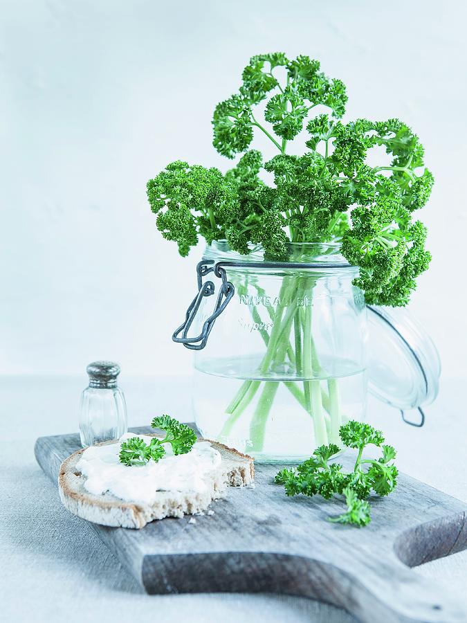 Curly-leaf Parsley In A Storage Jar, A Slice Of Rustic Bread With Herb Quark And Fresh Parsley Photograph by Schenk, Hendrik