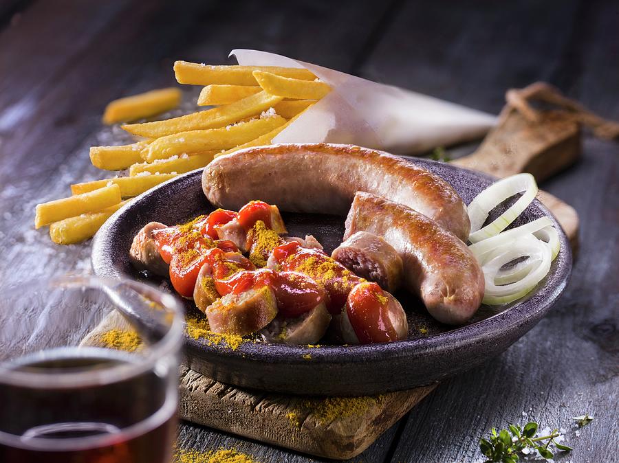Curry Sausages With Fries And Onion Rings Photograph by Christian Schuster
