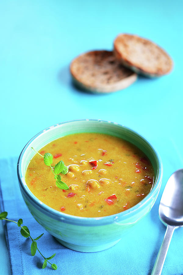 Curry Soup In A Rustic Bowl With Grilled Bread In The Background Photograph by Mariola Streim