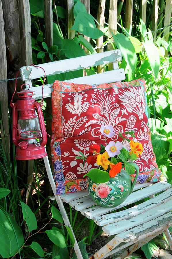 Cushion, Lantern & Posy In Jug On Old Garden Chair Photograph by Revier 51