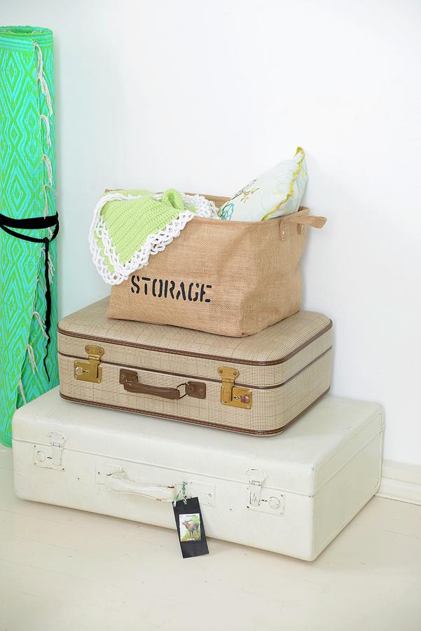 Cushions And Cloths In Bag On Top Of Stacked Suitcases Photograph by Revier 51