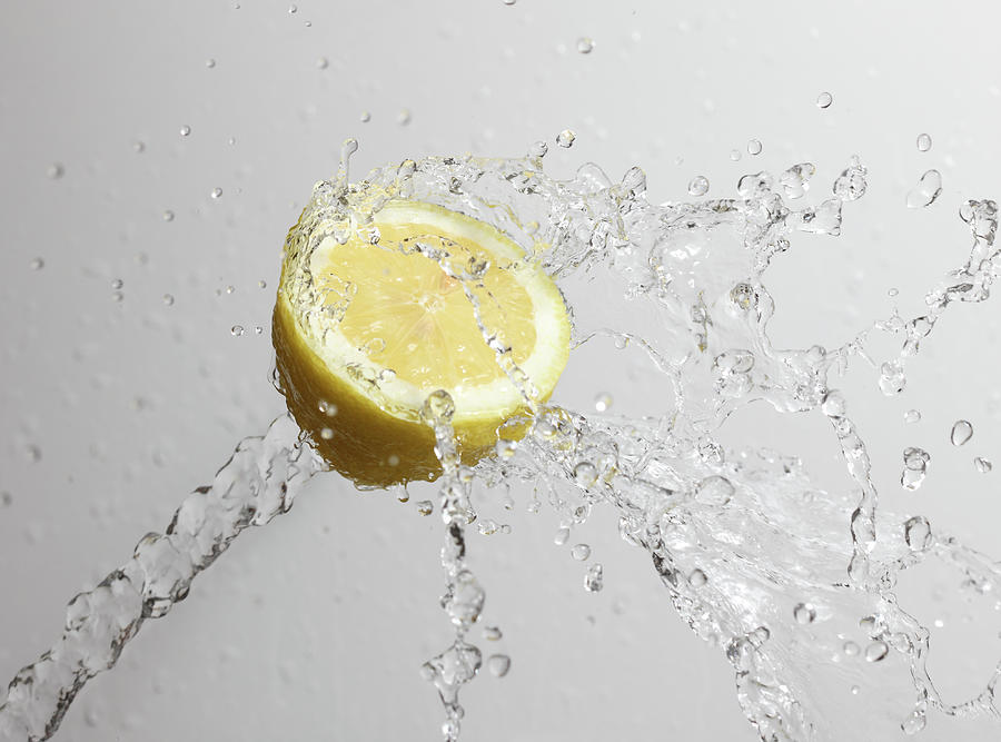 Lemon Photograph - Cut Lemon Splashed With Water by Vincenzo Lombardo