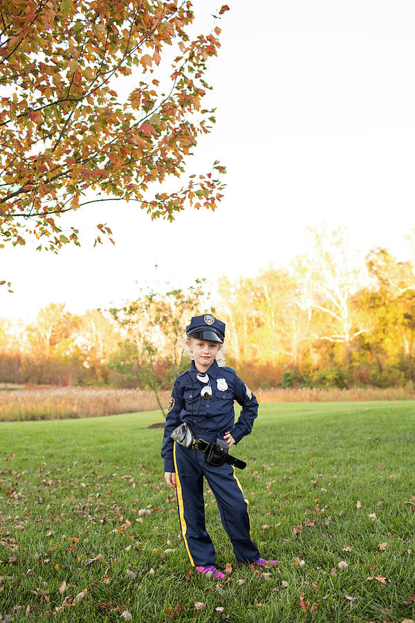 Cute Blonde Curly Hair Girl Poses In Police Officer Halloween Costume 