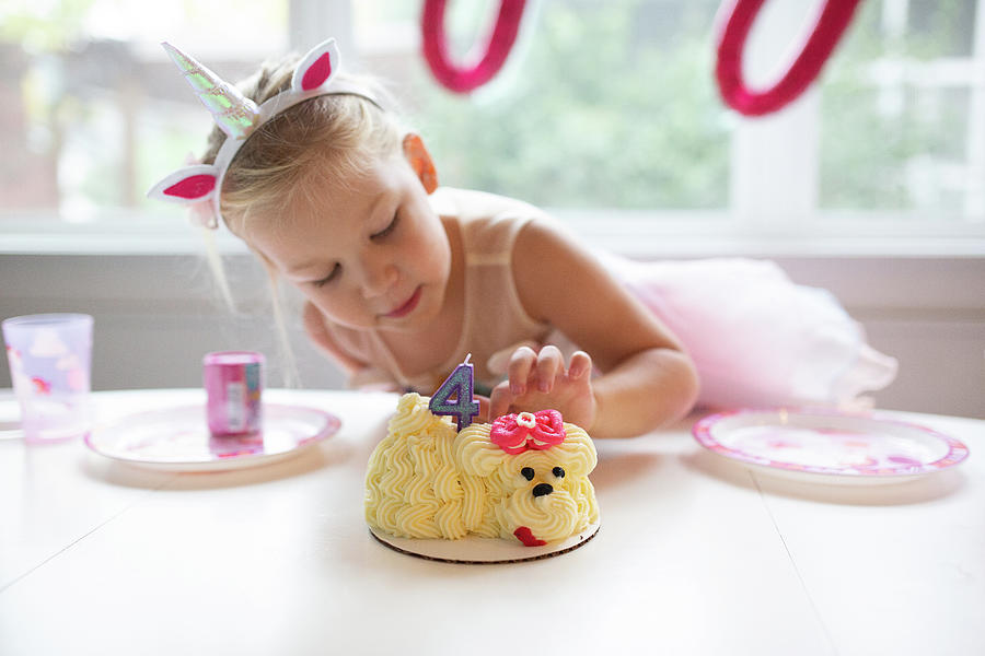 Cake Photograph - Cute Girl With Unicorn Headband Tasting Birthday Cake by Cavan Images