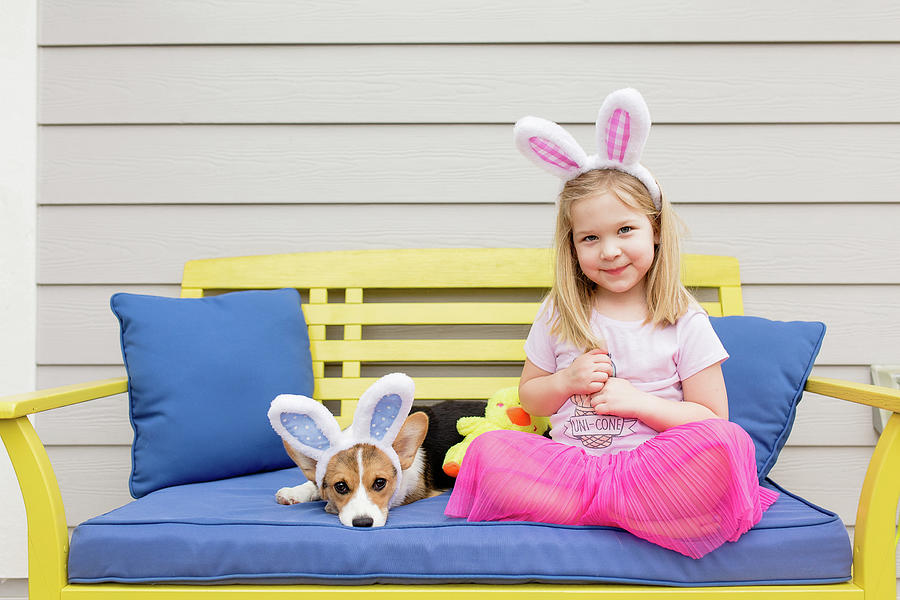 https://images.fineartamerica.com/images/artworkimages/mediumlarge/2/cute-little-blond-girl-sitting-with-corgi-puppy-both-with-bunny-ears-cavan-images.jpg