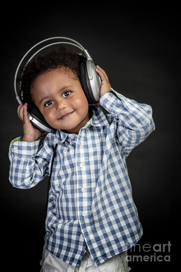 Cute little boy listens music Photograph by Anna Om