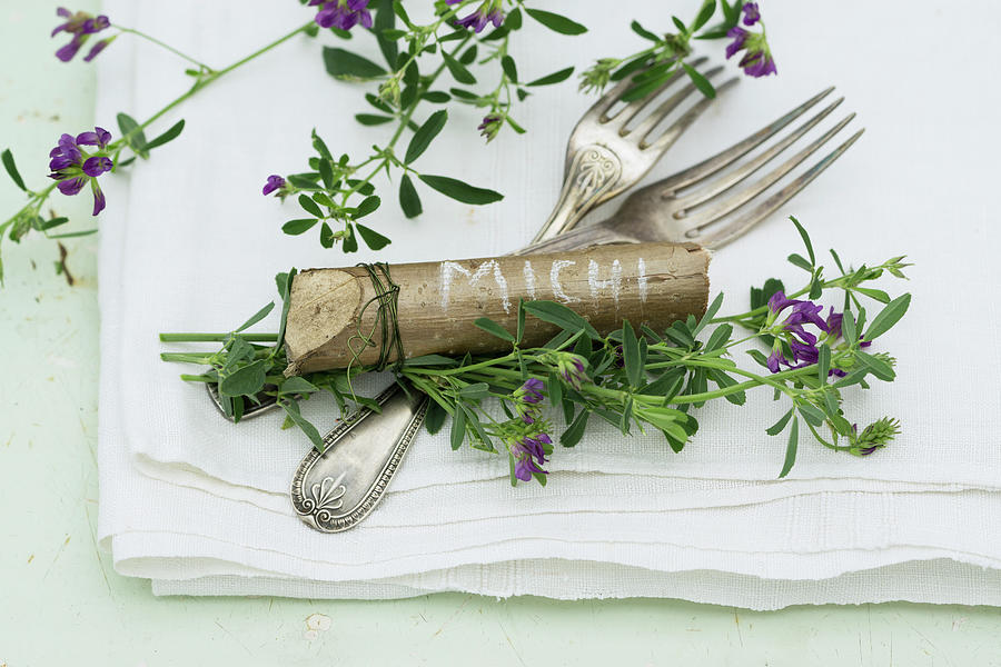 Cutlery And Place Markers Made From Pieces Of Hazel Wood Decorated With Purple-flowering Alfalfa medicago Sativa Photograph by Martina Schindler