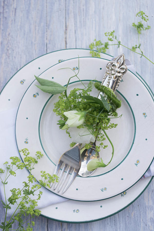Cutlery Arranged With Sweet Peas And Ladys Mantle On Plate Photograph by Martina Schindler