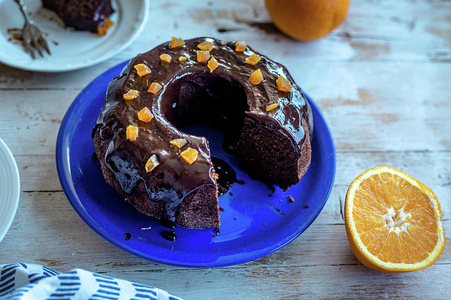 Cutting Chocolate Bundt Cake With Coconut Sugar And Orange Chocolate Glaze Photograph by Daniela Lambova