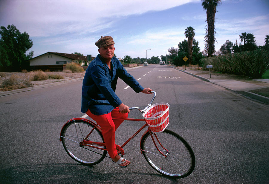 Cycling Capote Photograph by Slim Aarons