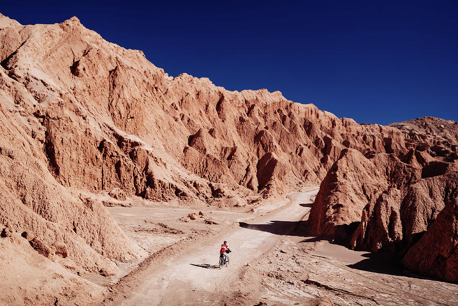 Cycling in the valley of death in Atacama Desert, Chile Photograph by Kamran Ali
