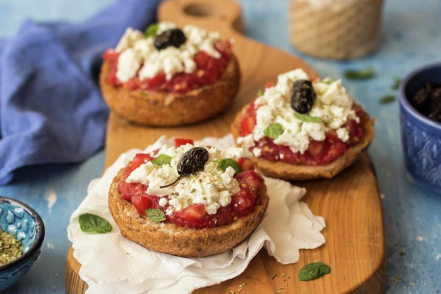 Dakos - A Traditional Dish From Crete With Farmhouse Bread, Tomatoes, Mizithra Cheese, Black Olives And Oregano Photograph by Zuzanna Ploch