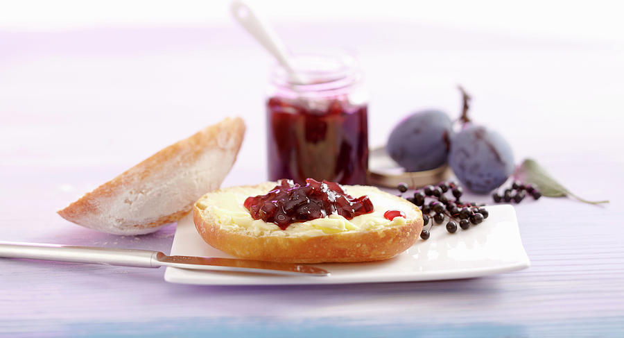 Damson And Elderberry Jam On A Bread Roll Photograph by Teubner Foodfoto