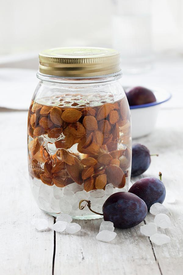 Damson Stones Preserved In A Jar Of Alcohol For Making Liqueur Or Schnapps Photograph by Sabine Lscher