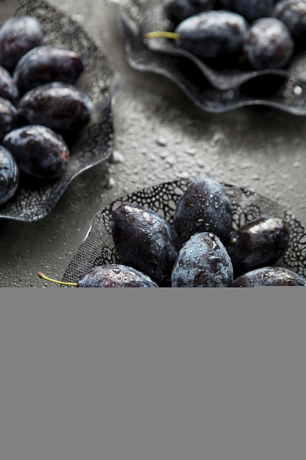 Damsons In Glass Bowls On A Black Surface Photograph by Aniko Takacs