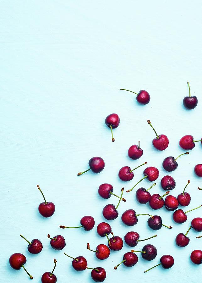 Dark Cherries On A Light Blue Background Photograph by Great Stock!