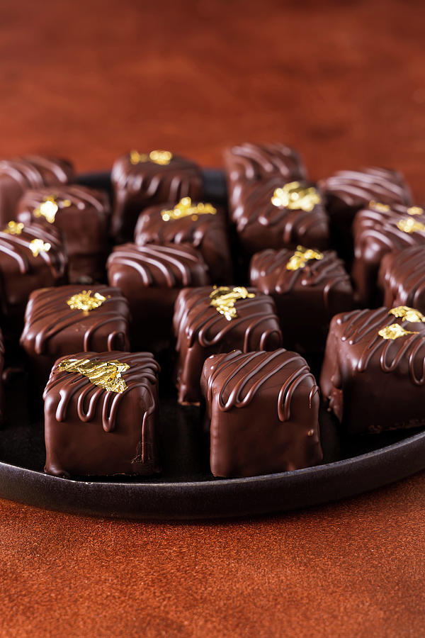 Dark Chocolate Homemade Truffles And Pralines Decorated With Edible Gold Photograph by Alla Machutt