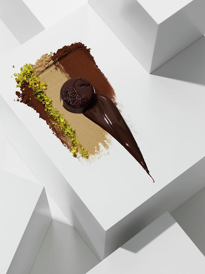 Dark Chocolate Praline On Various Chocolate Textures With Pistachios Photograph by Armin Zogbaum