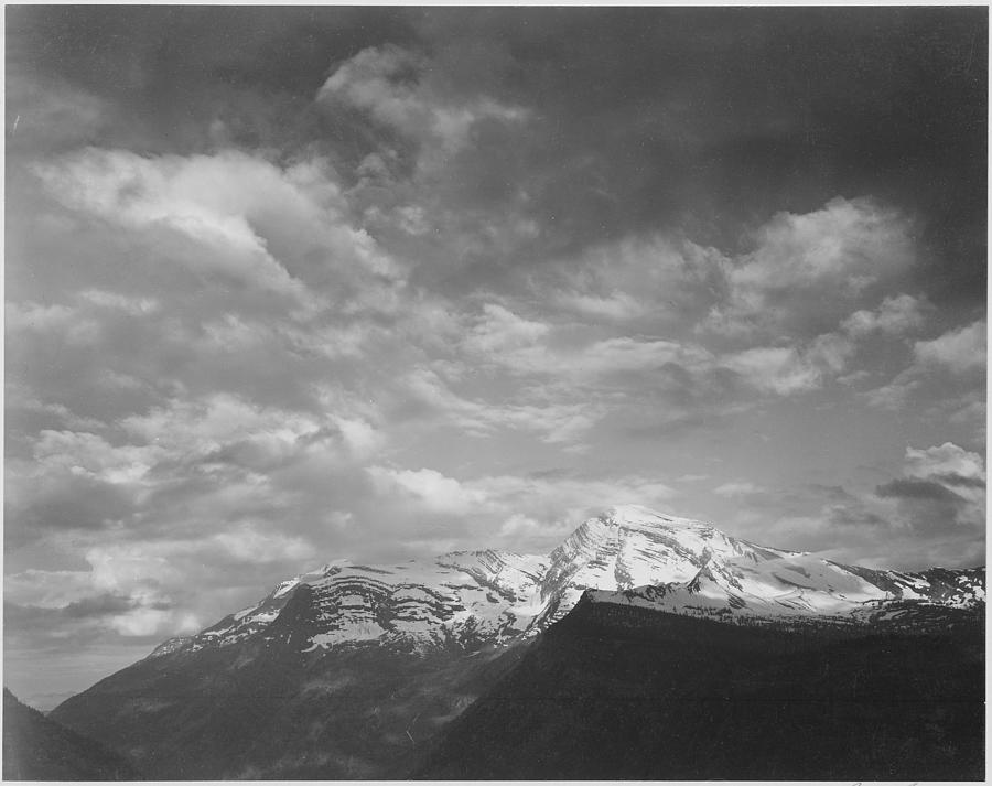 Dark foreground and clouds mountains highlighted Heavens Peak Glacier National Park Montana. 1933 - 1942 Painting by Ansel Adams