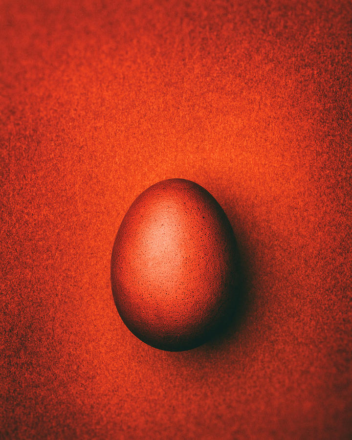 Dark Orange Easter Egg On A Dark Orange Background Photograph by Peter Rees